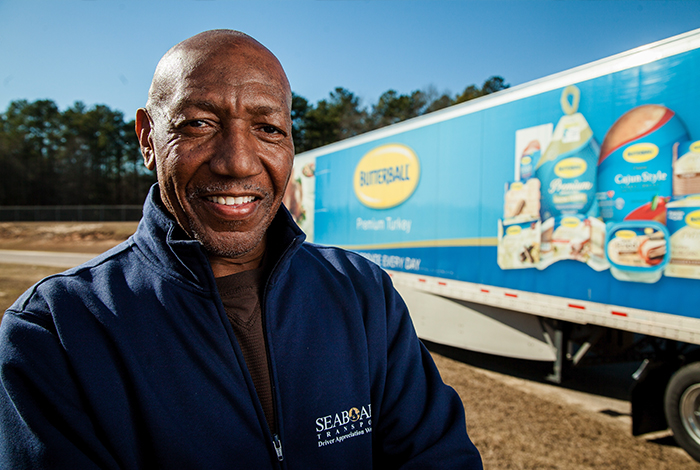 An employee in front of a distribution truck